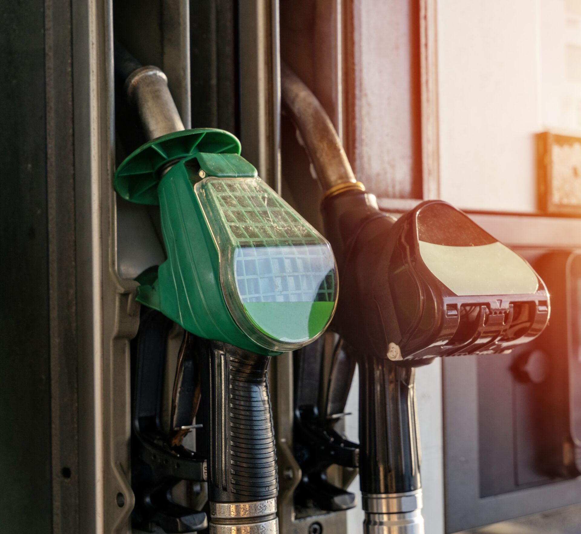Colorful petrol and diesel nozzles of the dispenser machine at the gas fuel station